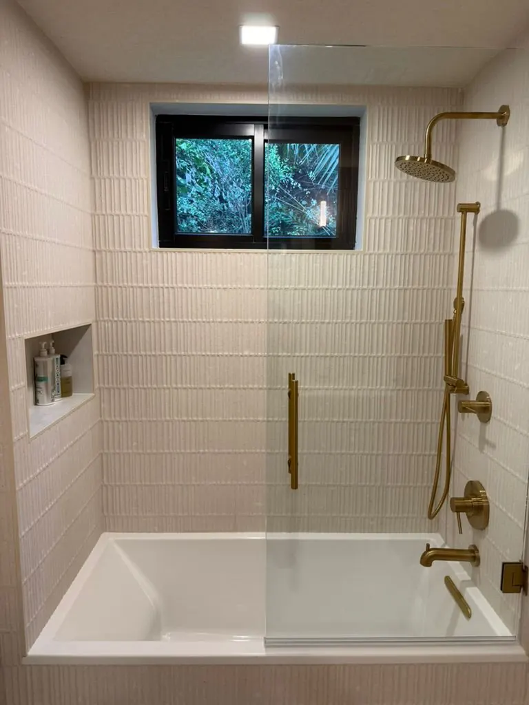 Tub & shower, brass fixtures — One Direct Mill project in South Florida