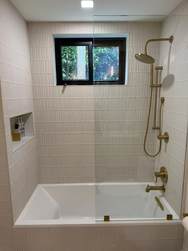Tub-shower, textured tile — One Direct Mill project in South Florida